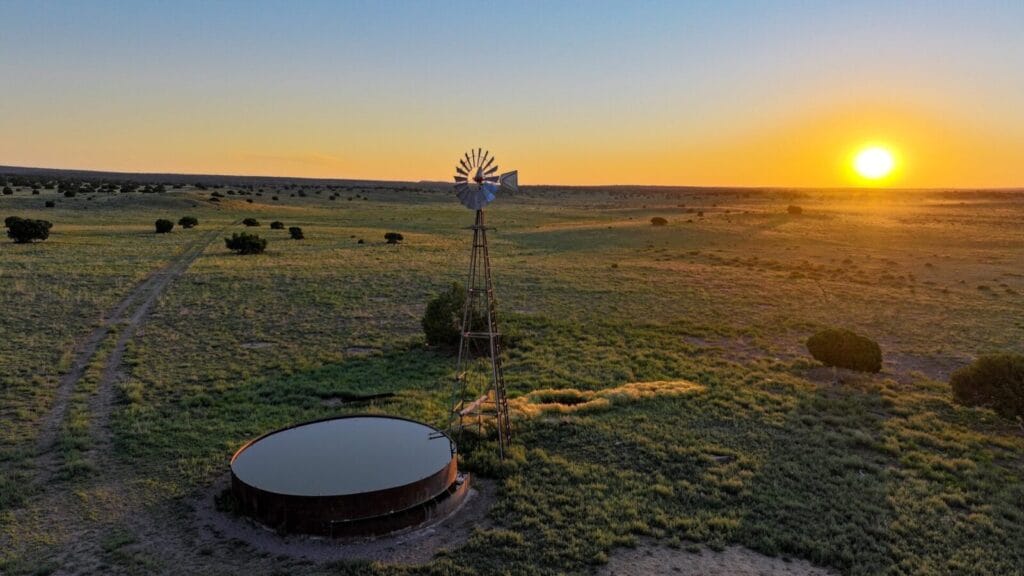 A serene New Mexico Agricultural landscape with Farm Equipment and Infrastructure, spread across Large open Acreage