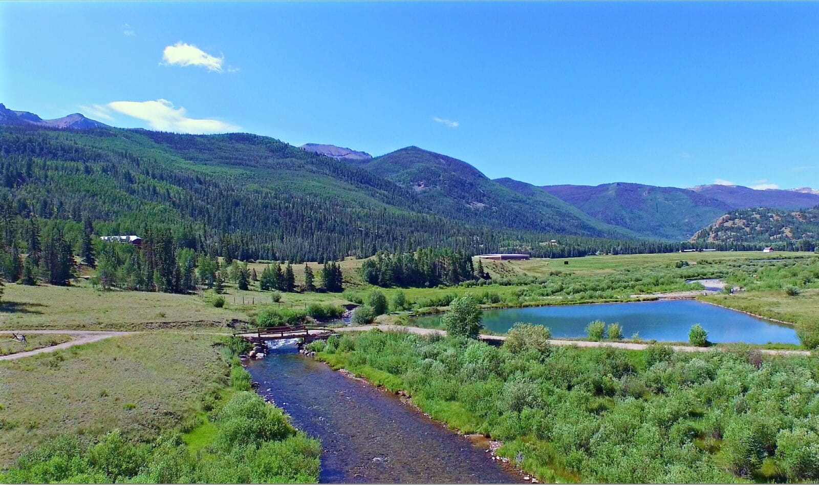 Live Water winding through expansive Colorado Property, Sleeping Ute Ranch, featuring Lush Pastures and Forested Mountains- A Colorado Ranch For Sale